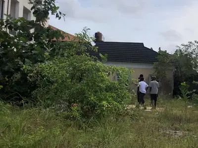 Full Plot of Sand-Filled Dry Land with Existing Building Around Skymal